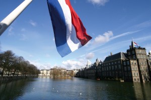 Dutch flag with the parliament buildings in the background